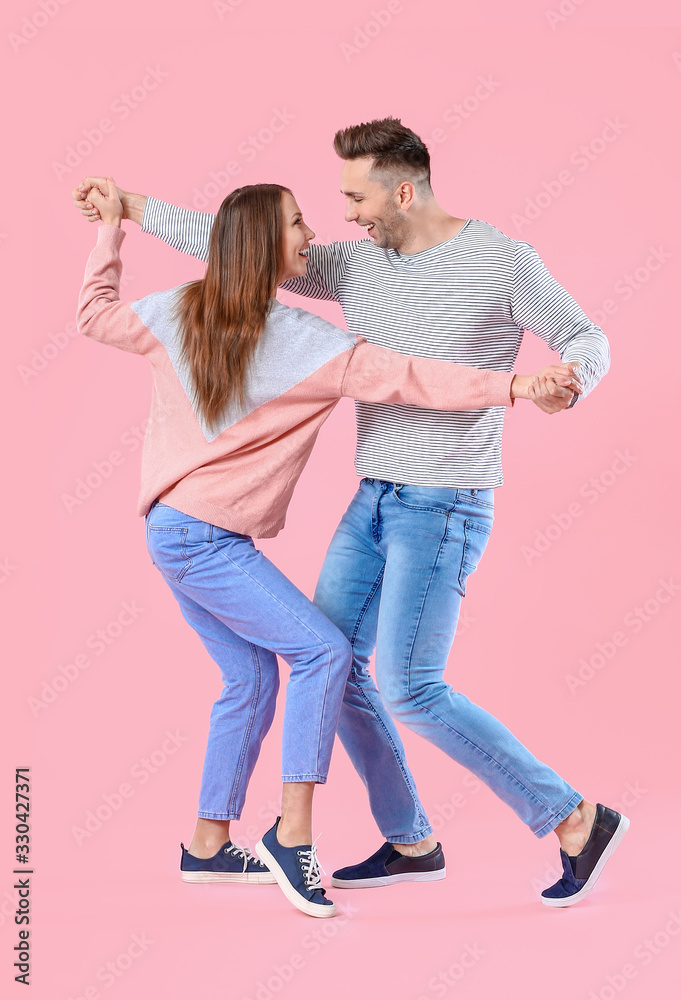 Happy couple dancing against color background Happy couple dancing against color background