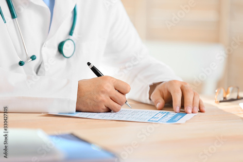 Young male doctor working i...