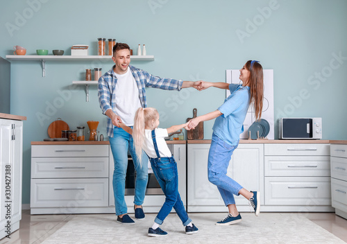 Happy family dancing in kit...
