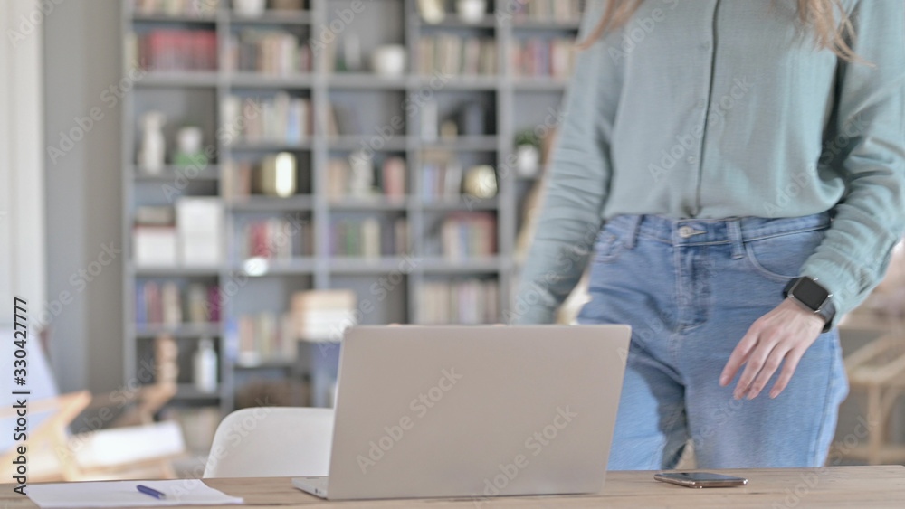 The Young Professional Coming back and Sitting down and Working on Laptop The Young Professional Coming back and Sitting down and Working on Laptop
