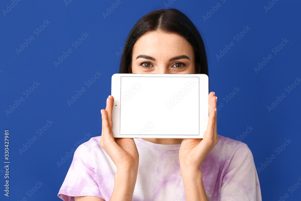 Beautiful young woman with tablet computer on color background Beautiful young woman with tablet computer on color background