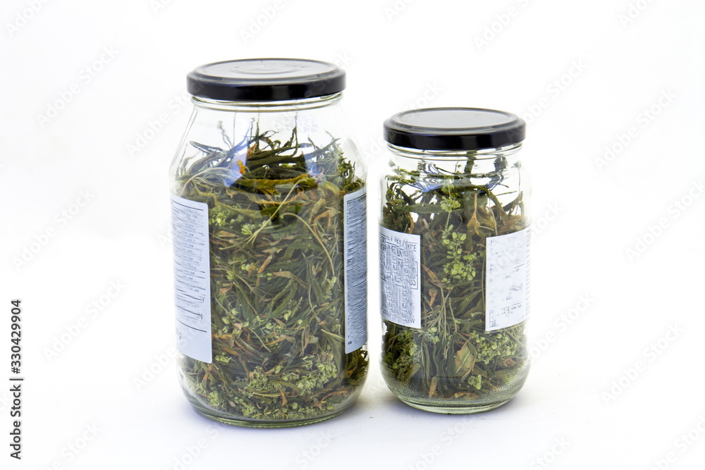 Two bottles of homegrown marijuana isolated on a clear background image with copy space in horizontal format Two bottles of homegrown marijuana isolated on a clear background image with copy space in horizontal format