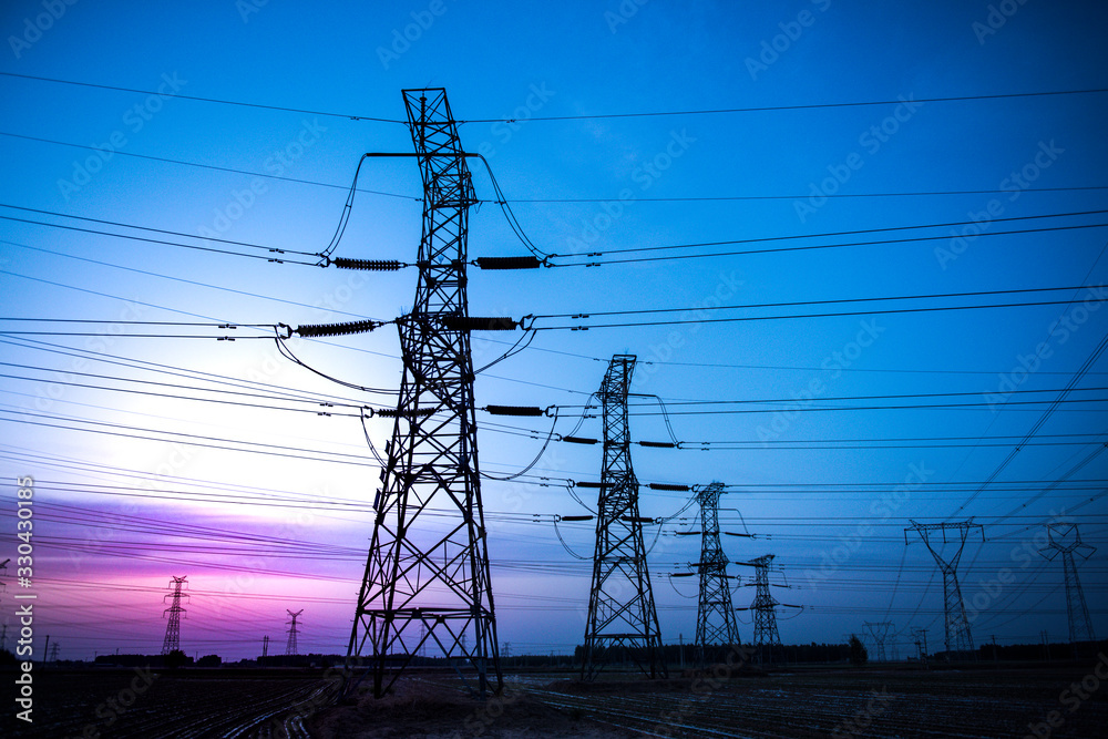 High voltage power cord. Sub-station. High voltage transmission tower. A distribution substation with power lines and transformers.