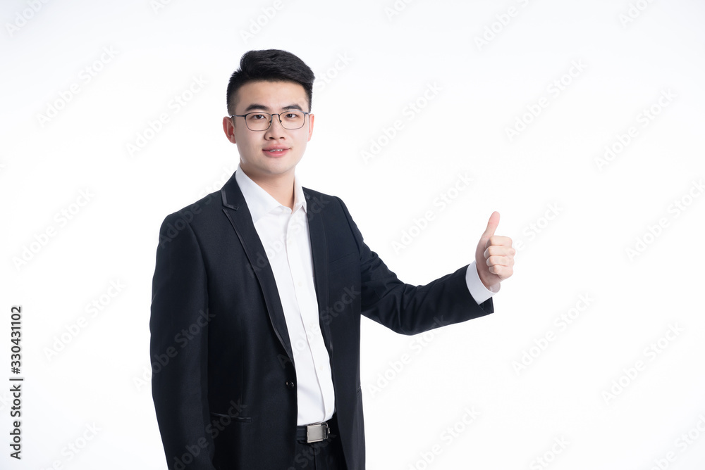 A young Asian man is using his mobile phone and laptop A young Asian man is using his mobile phone and laptop