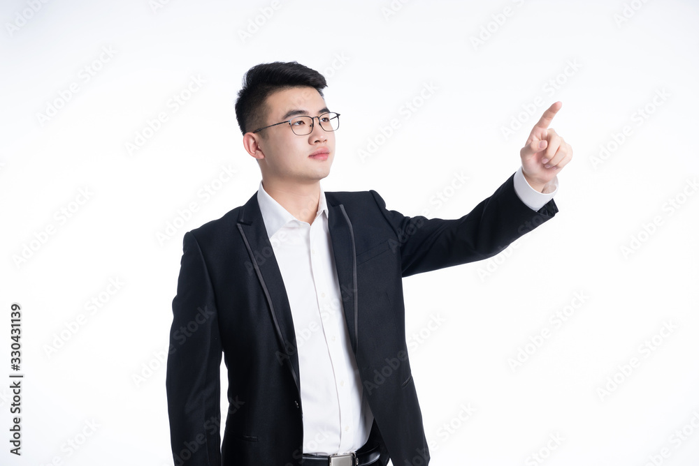 A young Asian man is using his mobile phone and laptop A young Asian man is using his mobile phone and laptop