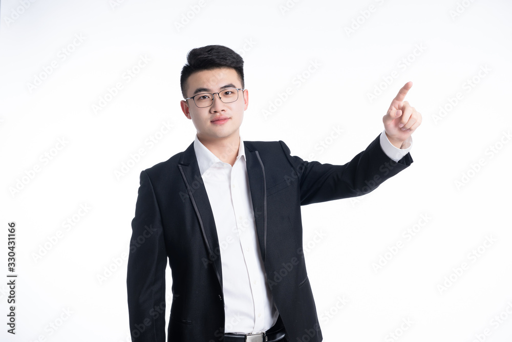 A young Asian man is using his mobile phone and laptop A young Asian man is using his mobile phone and laptop