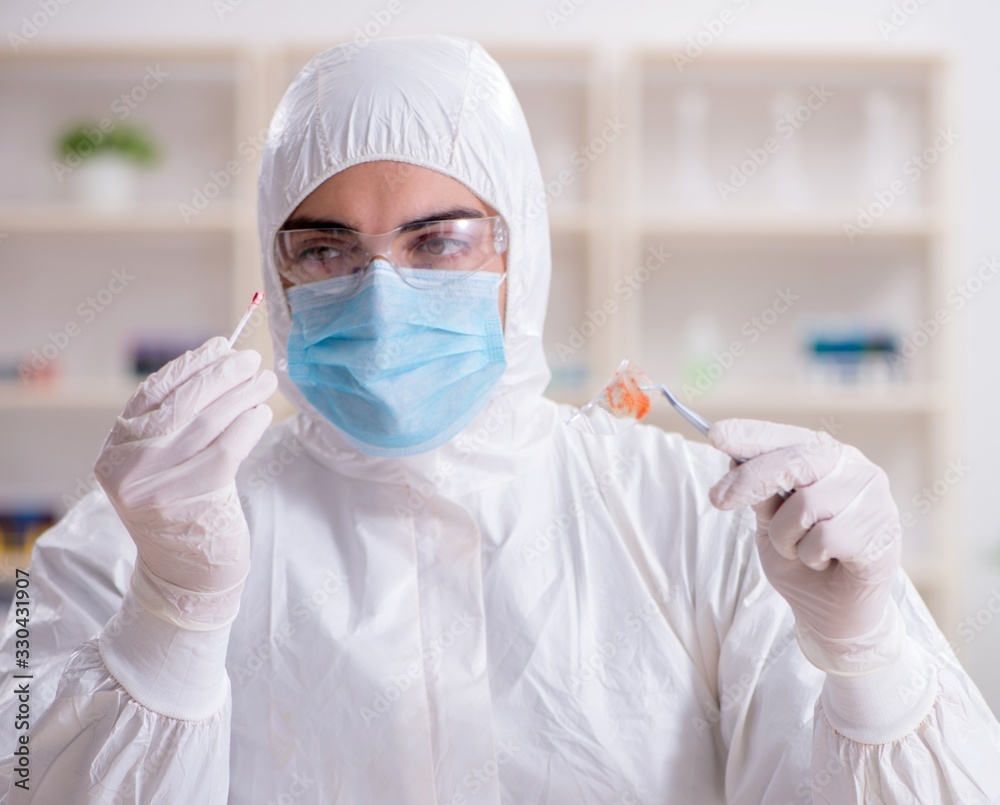 Expert criminologist working in the lab for evidence