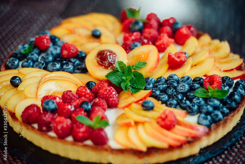 Classic simple new York cheesecake with berries and fruit, close-up view, selective focus