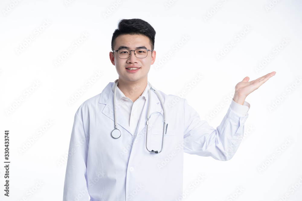 An Asian male doctor works on a laptop An Asian male doctor works on a laptop