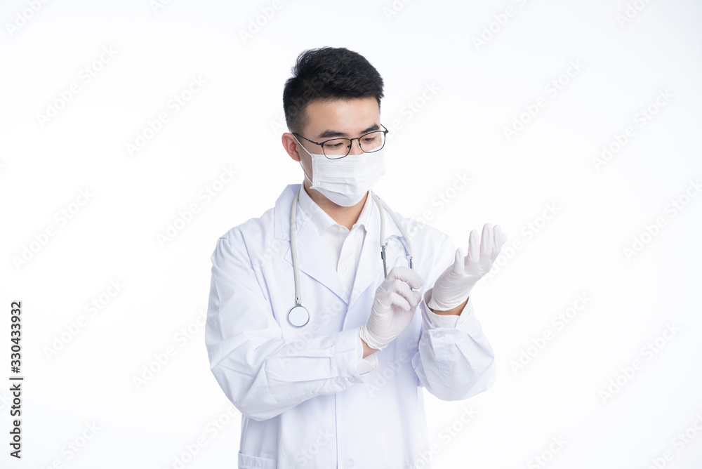 An Asian male doctor works on a laptop An Asian male doctor works on a laptop