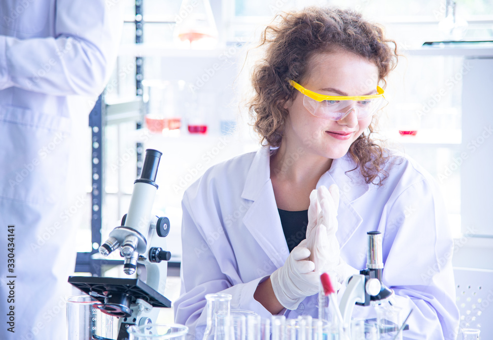 The scientist biologist or researcher putting personal protective equipment to prevent infection from virus or bacteria disease. The scientist biologist or researcher putting personal protective equipment to prevent infection from virus or bacteria disease.