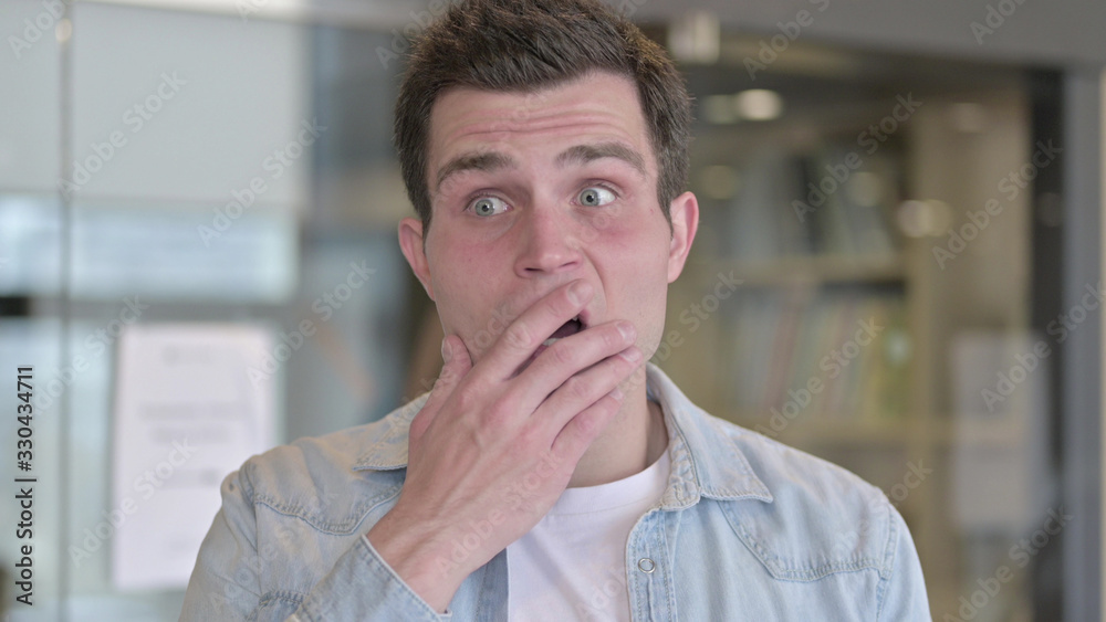 Naklejka premium The Portrait of Astonished Young Male Designer in Shock