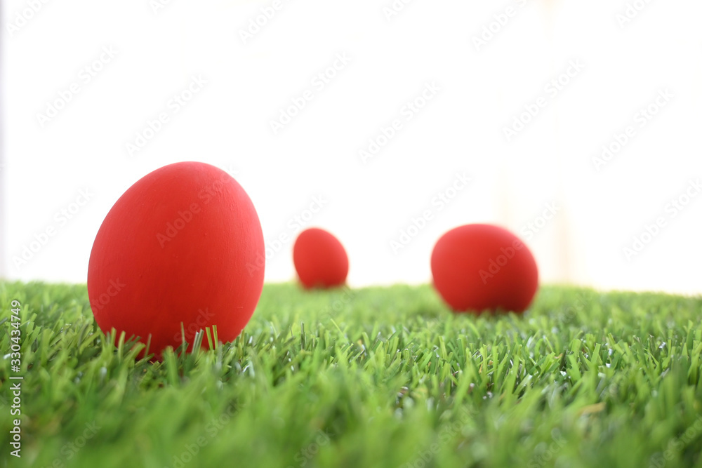 red easter egg on lawn green grass artificial with blank white background