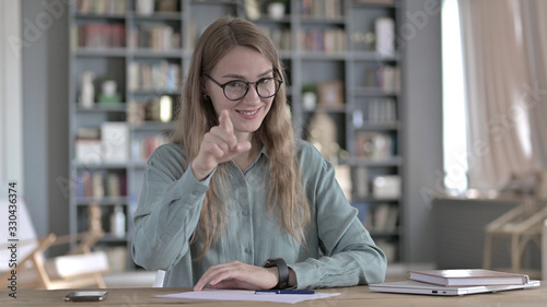 The Cheerful Young Woman Pointing Finger at Camera and Inviting © stockbakers