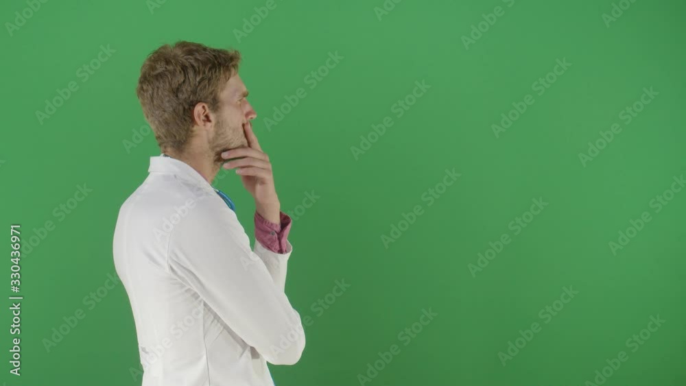 Adult Man Doctor Arms Crossed Analyzing Something On The Green Screen Studio Isolated Shot Against Green Screen Background Adult Man Doctor Arms Crossed Analyzing Something On The Green Screen Studio Isolated Shot Against Green Screen Background