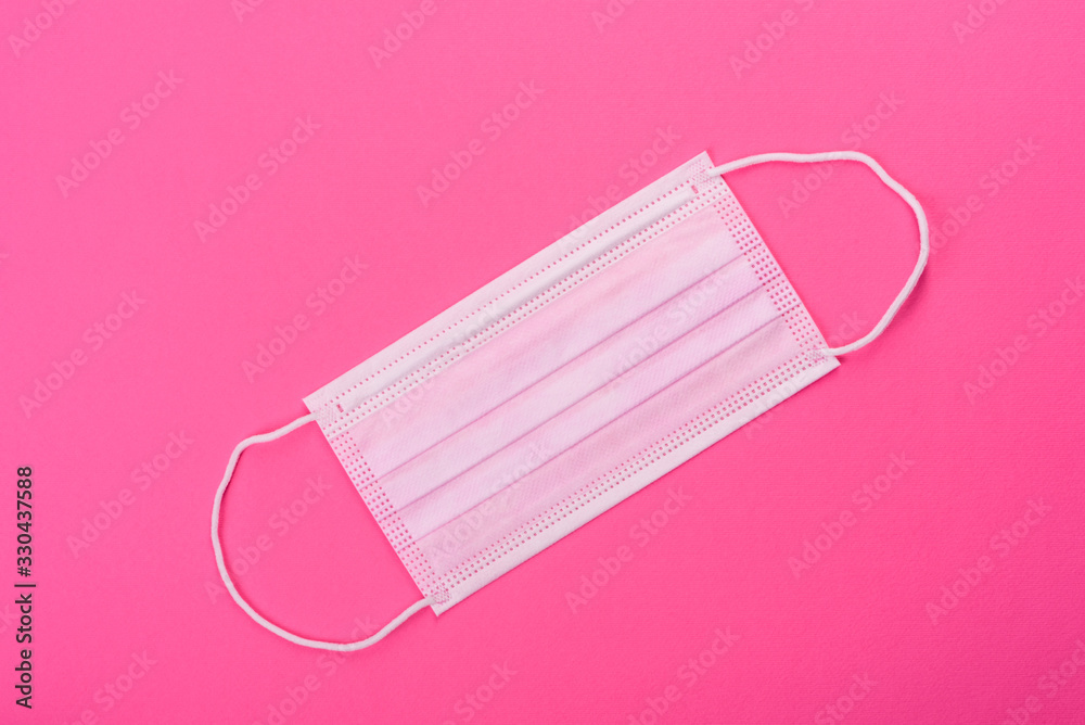 Medical mask on a colored background, a means of protection against coronovirus and epidemic Medical mask on a colored background, a means of protection against coronovirus and epidemic