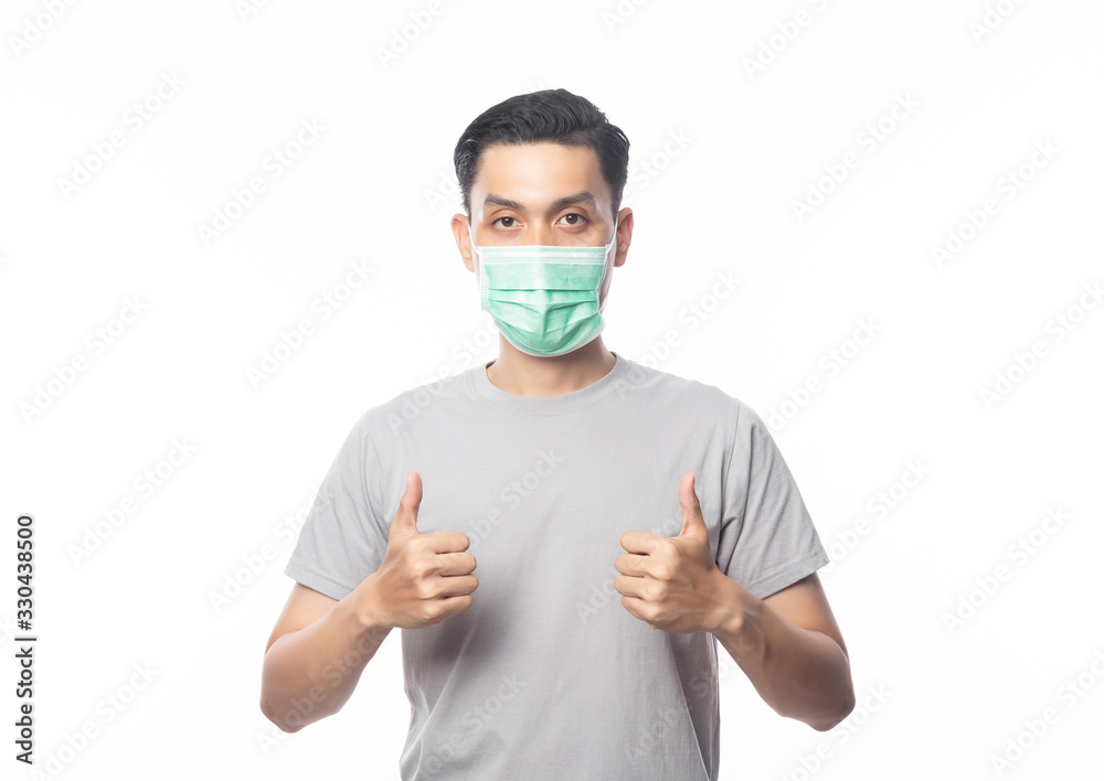 Young Asian Man wearing hygienic mask and showing thumbs up to prevent infection, 2019-nCoV or coronavirus. Airborne respiratory illness such as pm 2.5 fighting and flu. isolated on white background. Young Asian Man wearing hygienic mask and showing thumbs up to prevent infection, 2019-nCoV or coronavirus. Airborne respiratory illness such as pm 2.5 fighting and flu. isolated on white background.