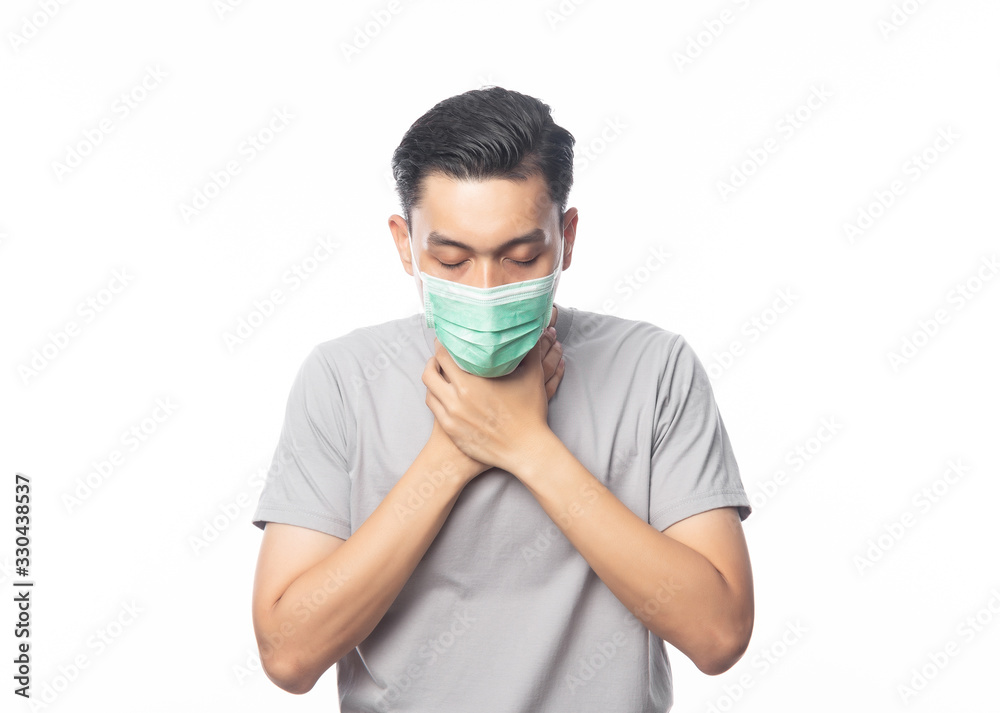 Young Asian Man in hygienic mask suffering sore throat, 2019-nCoV or coronavirus. Airborne respiratory illness such as pm 2.5 fighting and flu. Studio shot isolated on white background. Young Asian Man in hygienic mask suffering sore throat, 2019-nCoV or coronavirus. Airborne respiratory illness such as pm 2.5 fighting and flu. Studio shot isolated on white background.