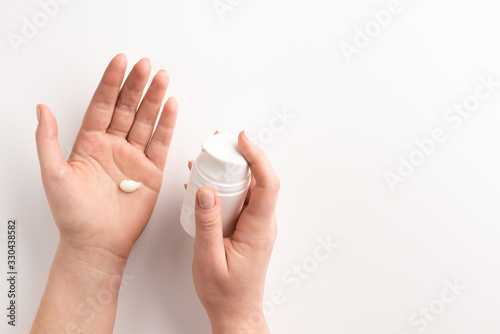 Women hands with container of cream isolated, on white background. Flat lay, top view, copy space. Organic cosmetic concept.