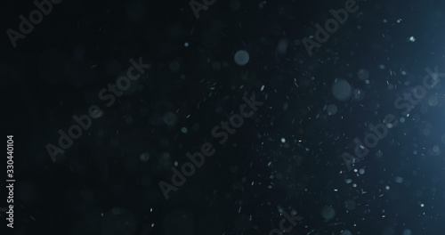 natural dust particles flow in air on black background photo