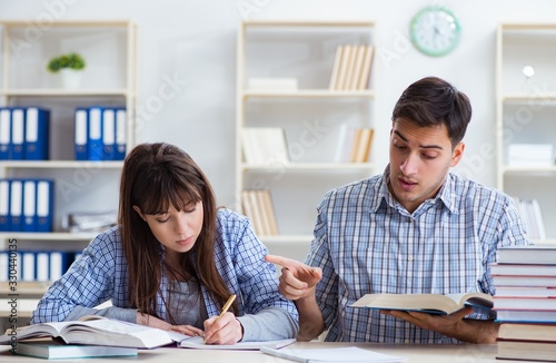 Students sitting and studying in classroom college