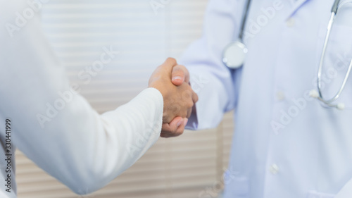 Close up of a doctor expressing his congratulations to the patient for illness recovery and before checking hospital. Doctor is congratulations the patient.