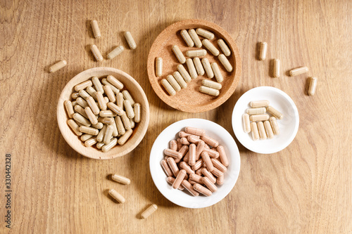 herbal pills on wooden background