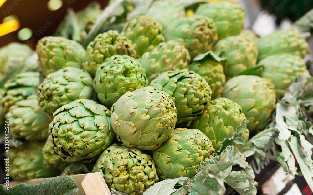 Fototapeta premium Fresh artichokes on market counter