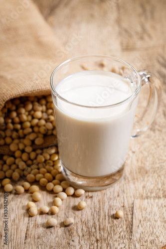 soy beans in gunny bag and soy milk in a glass.