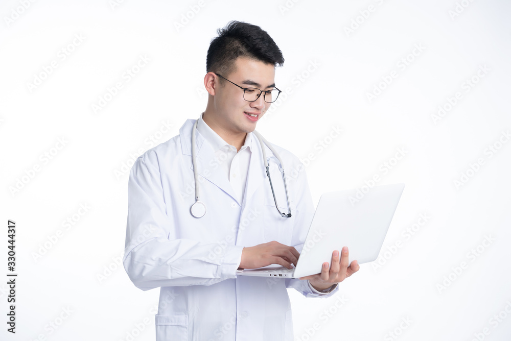 A young Asian doctor is using a device A young Asian doctor is using a device