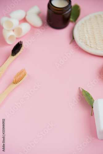 Cosmetic bath salt, grape gomaj for the face, coffee scrub for the body on a pink background.