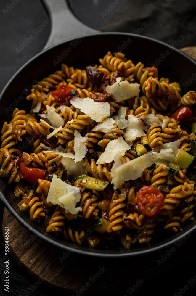 Homemade pasta with parmezan on skillet Homemade pasta with parmezan on skillet