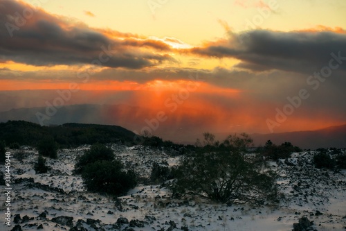 Dramatic Sunset On Volcanic Rock With Snow © ollirg