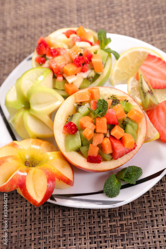fruit salad - apple with berryfruit, kiwi and melon
