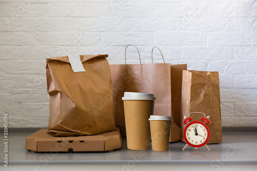 pizza boxes and coffee to go with noodles boxes on tabletop