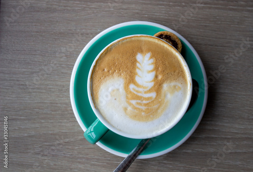 Canvas Print cappuccino cup on the brown wooden table.