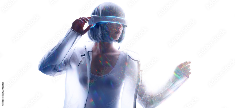 Beautiful woman with purple hair in futuristic costume over white background. Girl in glasses of virtual reality. Augmented reality, game, future technology, AI concept. VR. Blue neon light. Beautiful woman with purple hair in futuristic costume over white background. Girl in glasses of virtual reality. Augmented reality, game, future technology, AI concept. VR. Blue neon light.