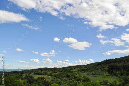 Beautiful dynamic sky above green hill. Natural background