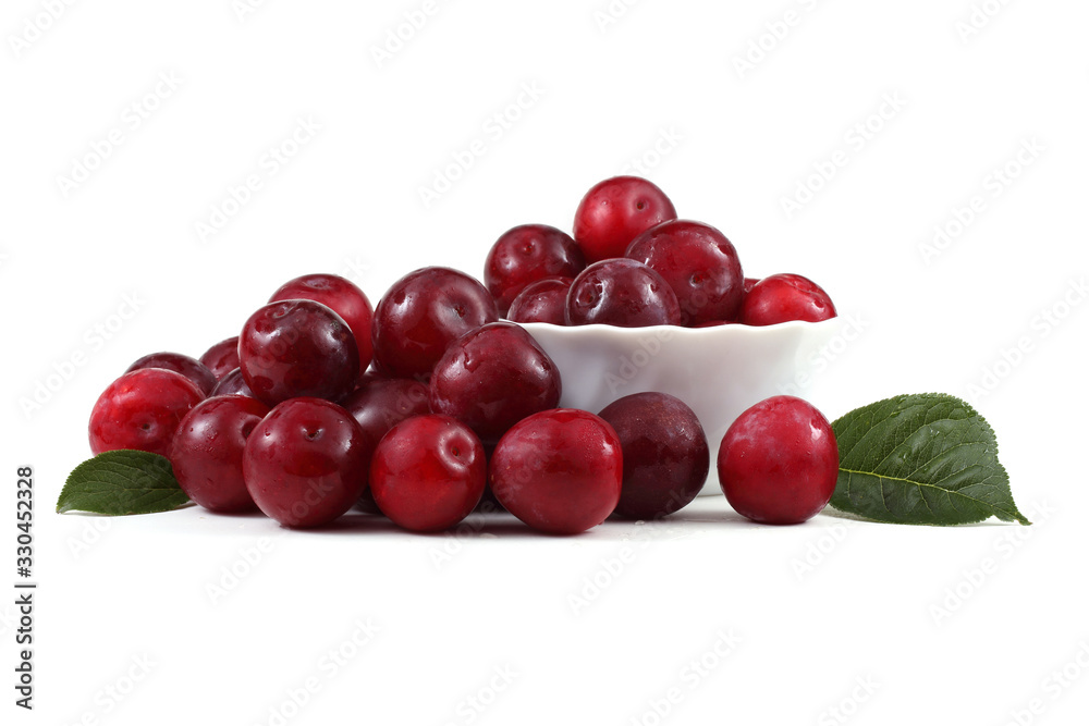 Red plums, dish and leaves Red plums, dish and leaves