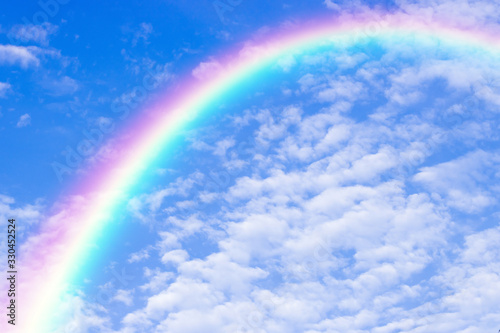 A beautiful rainbow in blue sky background. © Kritsada