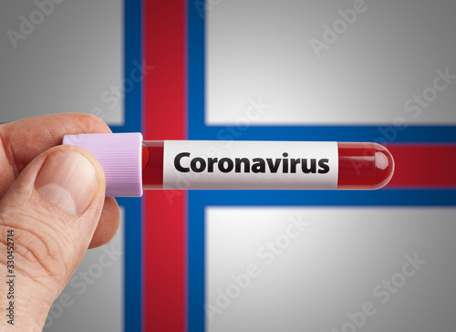 Scientist holding Coronavirus infected blood in test tube in front of Faroe Islands flag. Pandemic COVID-19 infection in countries in world concept.