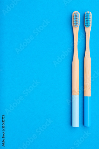 Toothbrushes on blue background top view