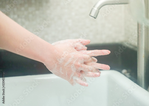 Woman washing hands in sink protect covid19 virus after contact environment.