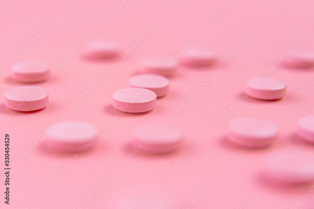 pink pills on a pink background