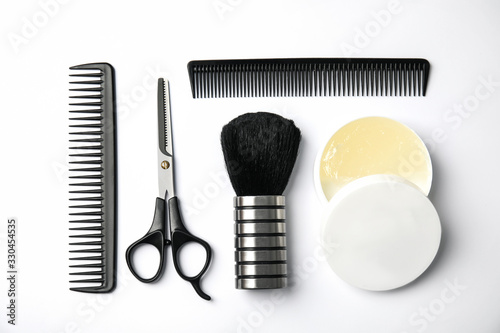 Professional hairstyling tools on white background, flat lay