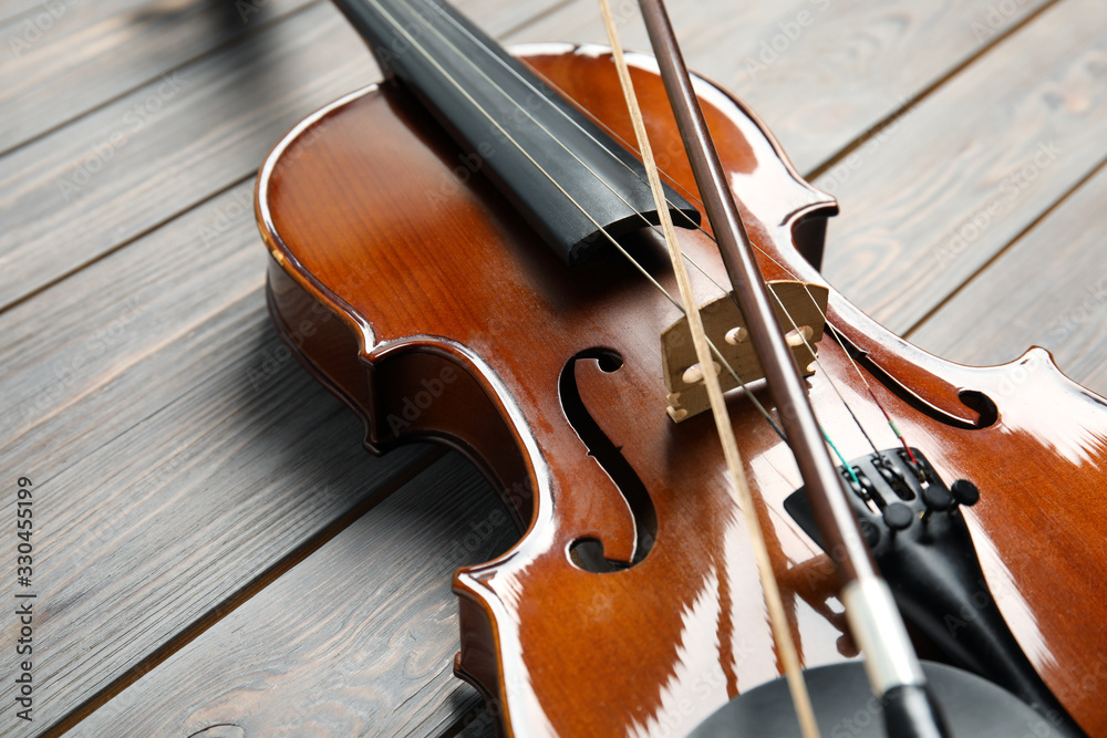 Classic violin and bow on wooden background, closeup Classic violin and bow on wooden background, closeup