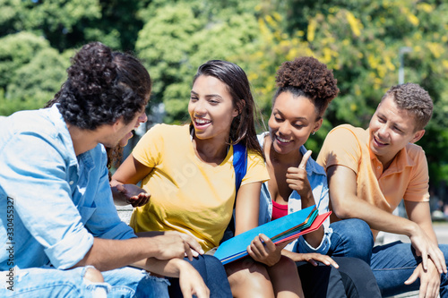 Group of talking international male and female students