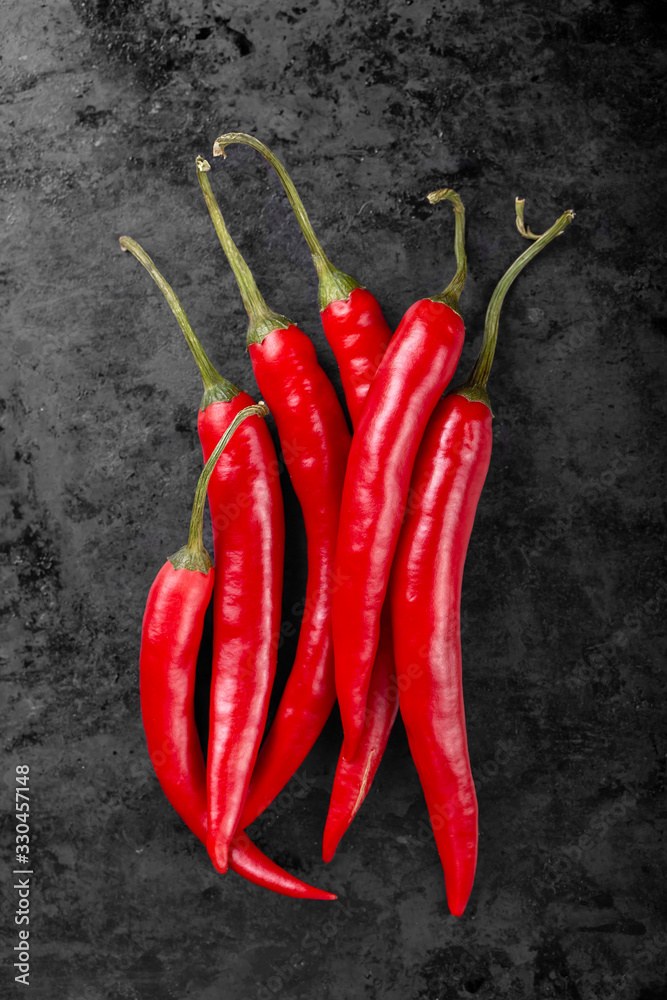 Red hot chili peppers on a black background.