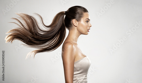Profile portrait of a beautiful woman with a long straight  hair.