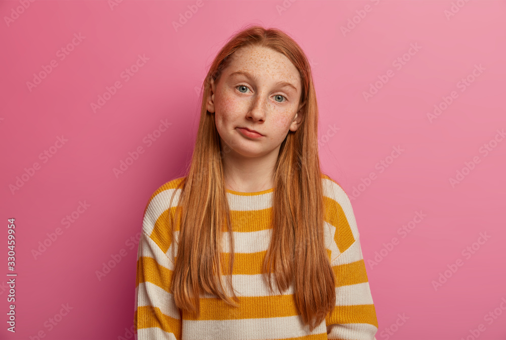 Unimpressed questioned girl with long foxy hair, has hesitant ...